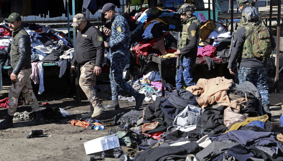 Security forces work at the site of a deadly bomb attack in Baghdad, Iraq, Thursday, Jan. 21, 2021. Iraq's military said twin suicide bombings at the Bab al-Sharqi commercial area in central Baghdad Thursday ripped through the busy market killing over two dozen and wounding over 70, with some in serious condition. (AP Photo/Hadi Mizban)