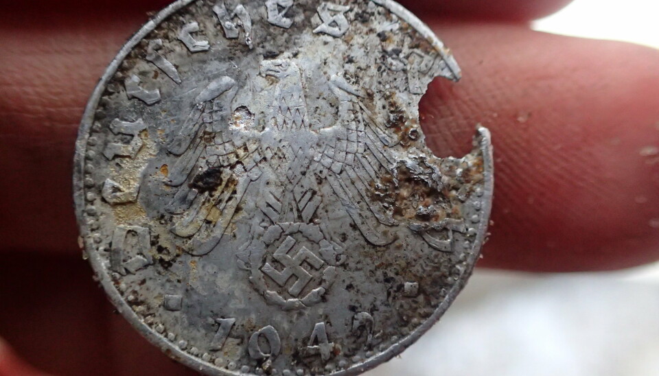 En mynt utstedt i Hitlers nazityske rike ble funnet blant levningene.