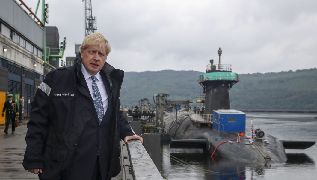 NUCLEAR POWER: Boris Johnson pictured in front of a Vanguard-class submarine. Each submarine can be armed with 16 Trident II intercontinental ballistic missiles (ICBMs) with nuclear warheads. The Vanguard class is the third largest submarine class in the world, after the Russian Typhoon and the American Ohio. NUCLEAR POWER: Boris Johnson pictured in front of a Vanguard-class submarine. Each submarine can be armed with 16 Trident II intercontinental ballistic missiles (ICBMs) with nuclear warheads. The Vanguard class is the third largest submarine class in the world, after the Russian Typhoon and the American Ohio.