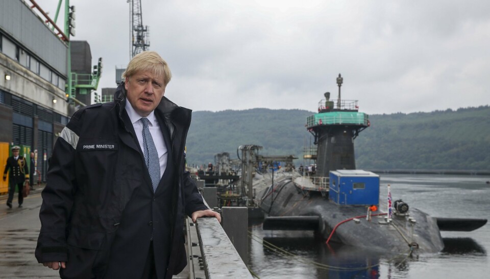 NUCLEAR POWER: Boris Johnson pictured in front of a Vanguard-class submarine. Each submarine can be armed with 16 Trident II intercontinental ballistic missiles (ICBMs) with nuclear warheads. The Vanguard class is the third largest submarine class in the world, after the Russian Typhoon and the American Ohio.