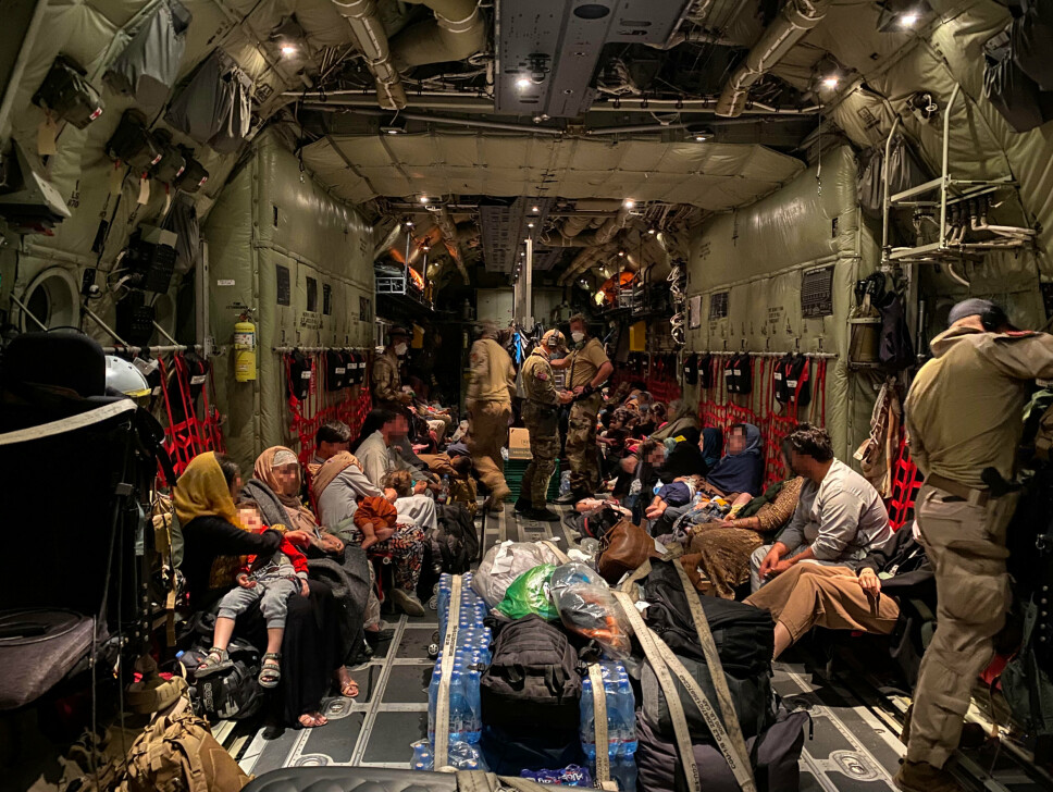 EVAKUERT: Her ser vi lasterommet til det norske C-130 J Hercules transportflyet med sivilt personell fra Kabul . Antall evakuerte har variert for hver tur, opplyser Luftforsvaret. (Personene på bildet et sladdet av Forsvaret).