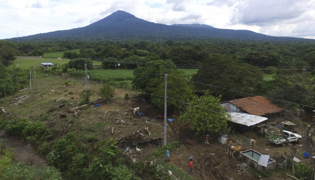 El Salvador er en republikk i Sør-Amerika. Sønnen til forsvarsministeren er nå bekreftet død etter en flystyrt i Stillehavet. Bildet viser en gård med vulkanen San Salvador, ikke langt fra kysten.