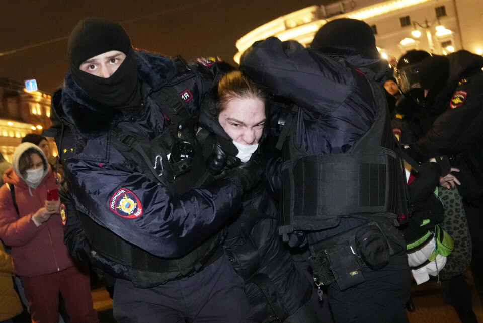 Police officers detain a demonstrator in St. Petersburg, Russia, Thursday, Feb. 24, 2022. Hundreds of people gathered in the centers of Moscow and St.Petersburg on Thursday, protesting against Russia's attack on Ukraine. (AP Photo/Dmitri Lovetsky)