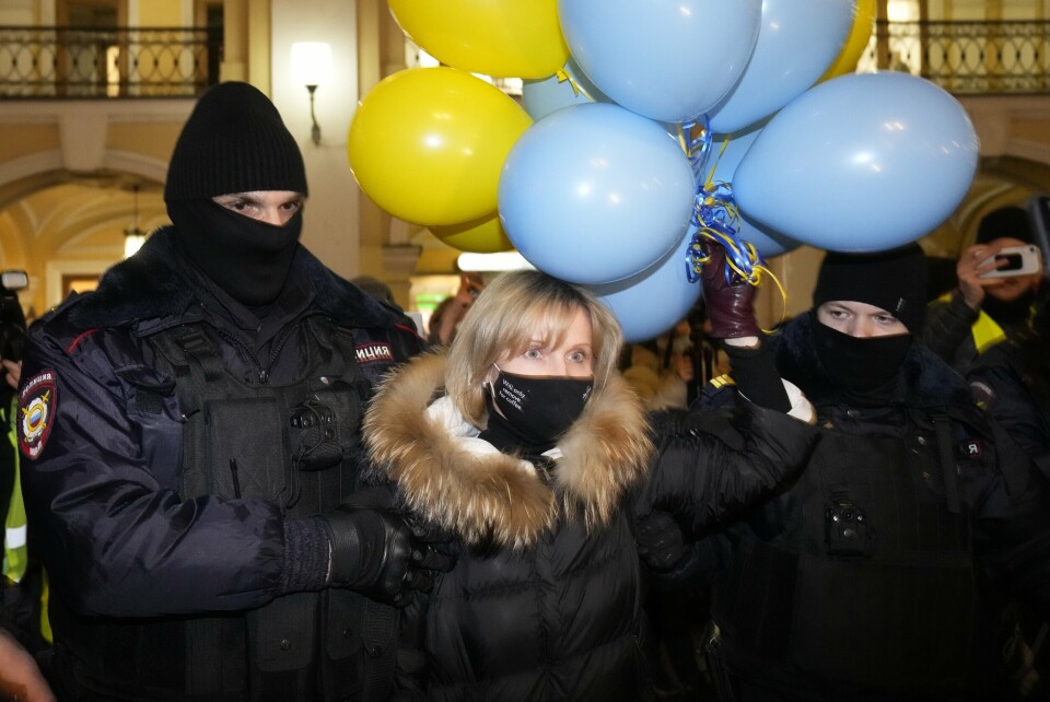 Police officer detain a woman during an action against Russia's attack on Ukraine in St. Petersburg, Russia, Friday, Feb. 25, 2022. Hundreds of people gathered in the center of Moscow on Thursday, protesting against Russia's attack on Ukraine. Many of the demonstrators were detained. Similar protests took place in other Russian cities, and activists were also arrested. (AP Photo/Dmitri Lovetsky)