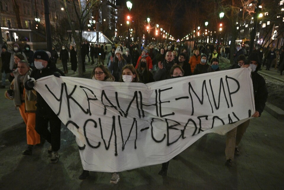 Demonstrators march with a banner that reads: "Ukraine - Peace, Russia - Freedom", in Moscow, Russia, Thursday, Feb. 24, 2022, after Russia's attack on Ukraine. Hundreds of people gathered in the center of Moscow on Thursday, protesting against Russia's attack on Ukraine. Many of the demonstrators were detained. Similar protests took place in other Russian cities, and activists were also arrested. (AP Photo/Dmitry Serebryakov)