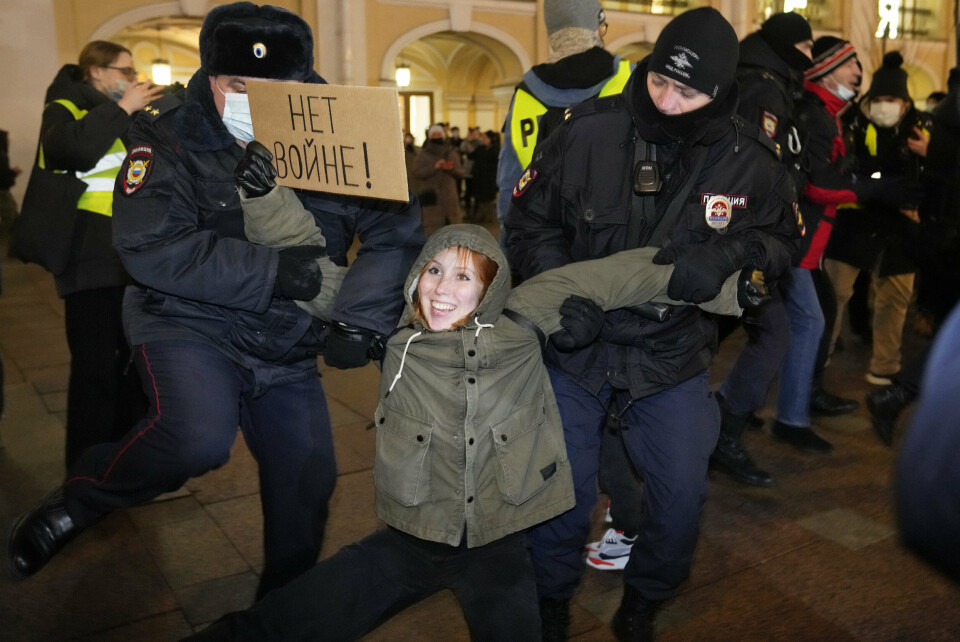 Police officers detain a demonstrator holding a sign reading 'No war!' during an action against Russia's attack on Ukraine in St. Petersburg, Russia, Thursday, Feb. 24, 2022. Hundreds of people gathered in the center of Moscow on Thursday, protesting against Russia's attack on Ukraine. Many of the demonstrators were detained. Similar protests took place in other Russian cities, and activists were also arrested. (AP Photo/Dmitri Lovetsky)