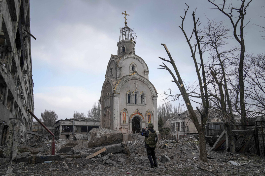 MARIUPOL: En ukrainsk soldat fotograferer en ødelagt kirke i havnebyen Mariupol.