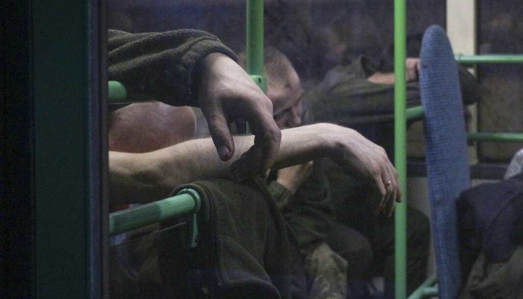 Ukrainske tjenestemenn sitter i en buss etter at de ble evakuert fra det beleirede stålverket Azovstal, nær et fengsel i Olyonivka, på territorium under regjeringen til Folkerepublikken Donetsk, tirsdag 17. mai.