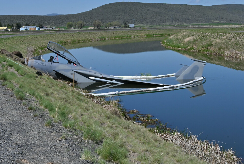 VÅTT HAVARI: Et F-15D havnet i en irrigasjonskanal ved siden av rullebanen til Kingsley Field i Oregon, 15. mai 2023. Bildet viser også tiltak for forhindre lekkasje av drivstoff.