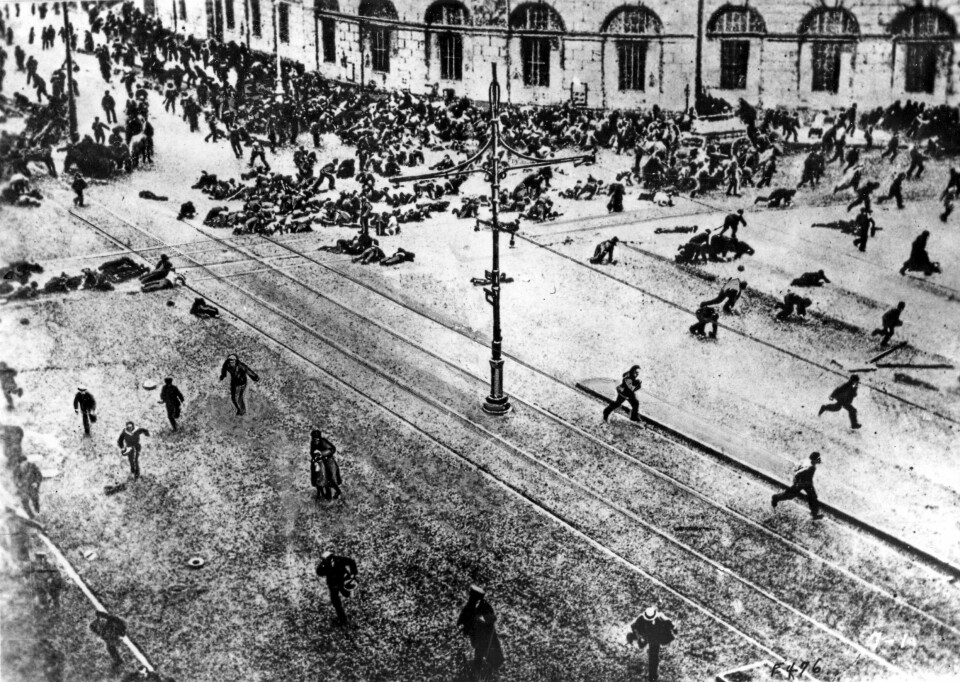 1917: Folk flykter fra maskingeværild i en hovedgate i St.Petersburg under revolusjonen.