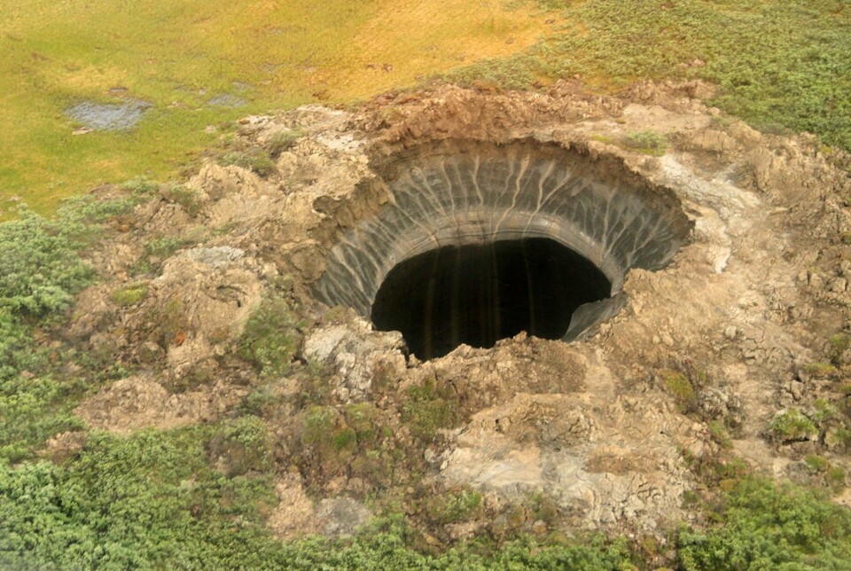 KRATER: Kratre som dette på Jamalhalvøya i Sibir begynte å dukke opp for rundt ti år siden. Kratrene kan bli opptil 50 meter i diameter. Bildet er tatt i 2014.